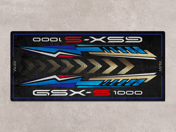 Suzuki GSX-S1000 garage mat in Triton Blue. Premium pit mat for track days, motorcycle gear, and rider setup zone.
