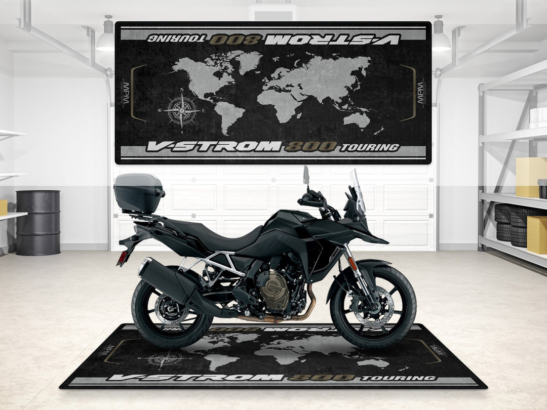 Suzuki V-Strom 800 Touring in Sparkle Black on garage mat. Premium parking mat for motorcycle gear setup.