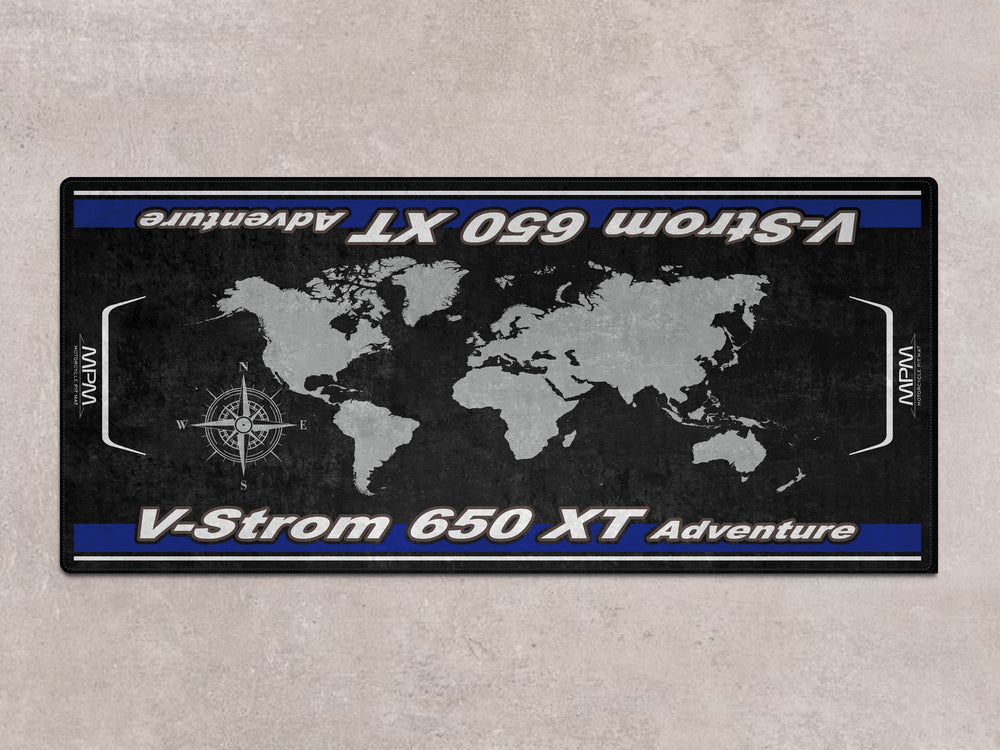 Adventure-ready floor cover for Suzuki 650 XT. Motorcycle parking mat for garage or pit setup.