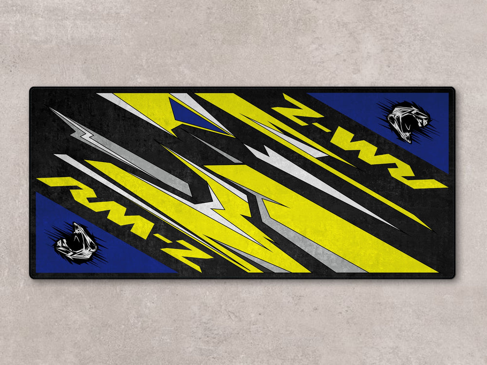 Motocross setup with RM-Z on Thermoplastic Rubber pit mat. Rugged floor cover for garage floor protection and rider gear.