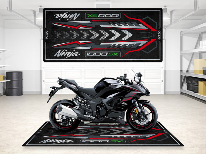 Graphite gray Ninja 1000SX garage mat with red accents and arrow design, perfect for track prep and display.