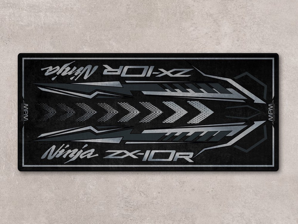 Flat spark black ZX-10R motorcycle display rug with Thermoplastic Rubber base for garage floor protection.