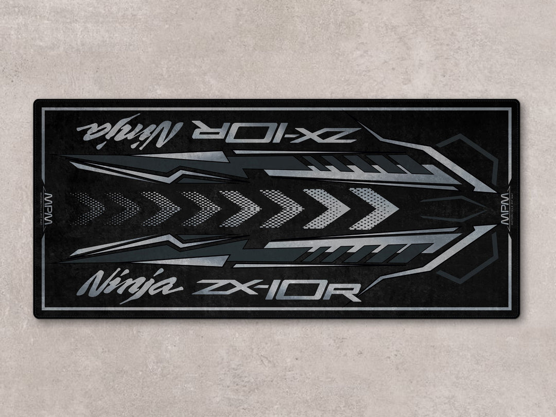 Flat spark black ZX-10R motorcycle display rug with Thermoplastic Rubber base for garage floor protection.