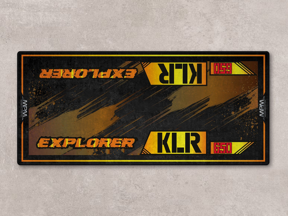 Bold explorer-themed rug for KLR 650. Thermoplastic Rubber base for garage floor protection and rider setup.