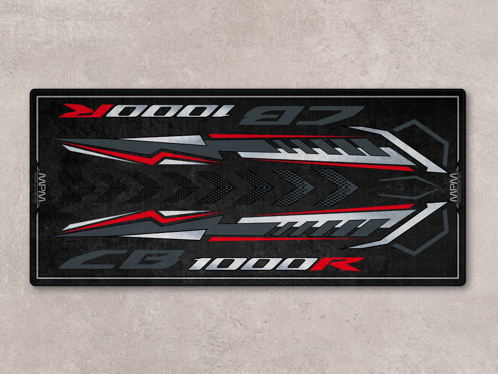 CB1000R pit mat in black, red, and gray. A rugged floor cover for showroom display, racetrack use, or motorcycle gear zone.