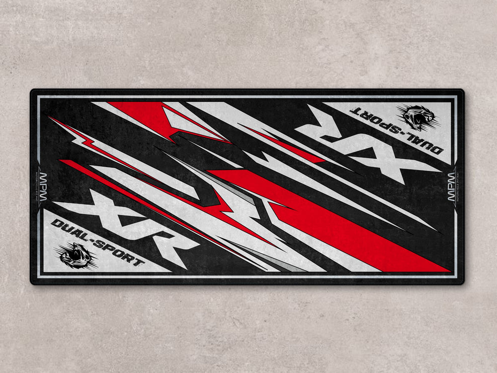 XR650 motorcycle pit mat with red-white accents. Heavy-duty floor cover for riders and dual sport garages.