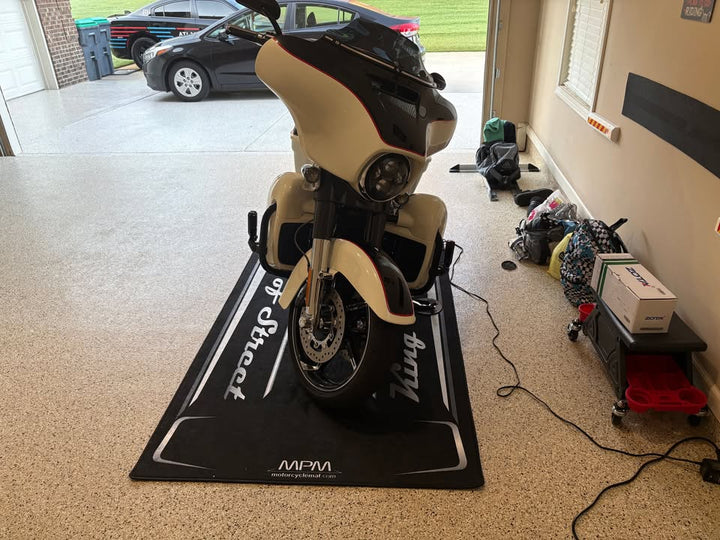 Motorcycle simulator on a mat in a garage setting