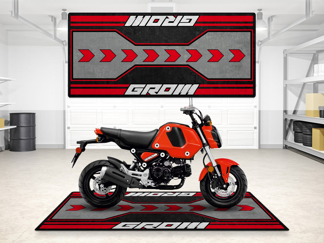 Honda Grom garage mat in red and grey. Compact floor cover for motorcycle display and garage floor protection.