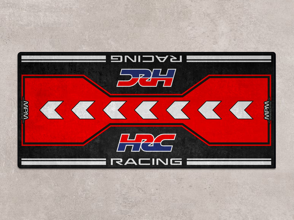 HRC-themed parking mat with racing arrows. Durable floor cover for racetrack prep, motorcycle gear area, or superbike garage.