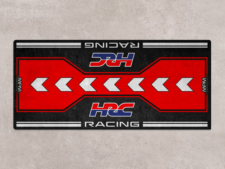 HRC-themed parking mat with racing arrows. Durable floor cover for racetrack prep, motorcycle gear area, or superbike garage.