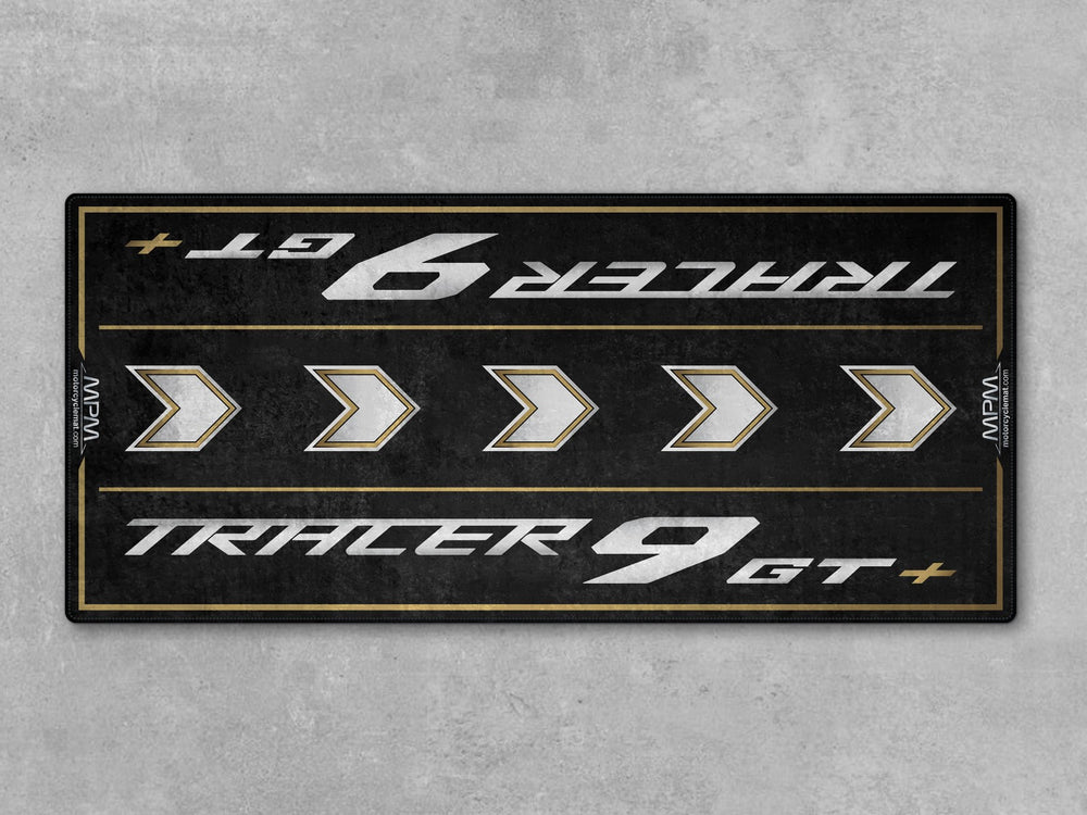 Black and gold Thermoplastic Rubber motorcycle mat for Tracer 9 GT+, protects garage floor with style and performance.