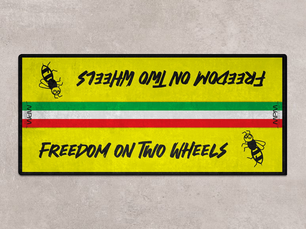 Garage mat for Vespa Primavera or Sprint. A perfect parking mat with vibrant rug design and racetrack-ready bee artwork.