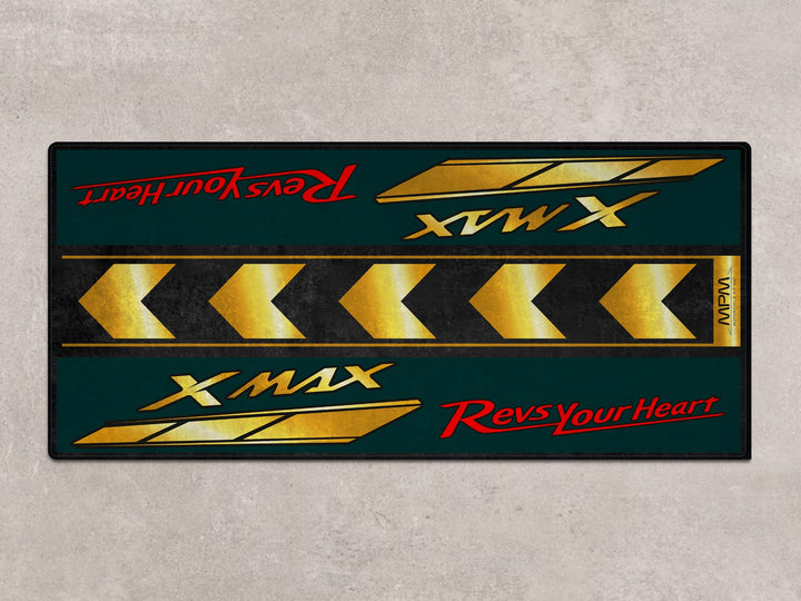Garage floor rug with bold yellow chevrons under Yamaha XMAX 300. Ideal for rider essentials and motorcycle display.