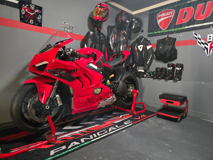 Ducati Panigale V4 superbike display on custom pit mat, non-slip motorcycle floor cover in real show environment.