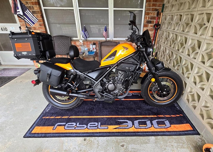 Honda Rebel 300 cruiser on custom motorcycle pit mat in outdoor porch garage, non-slip floor cover for daily rider setup.