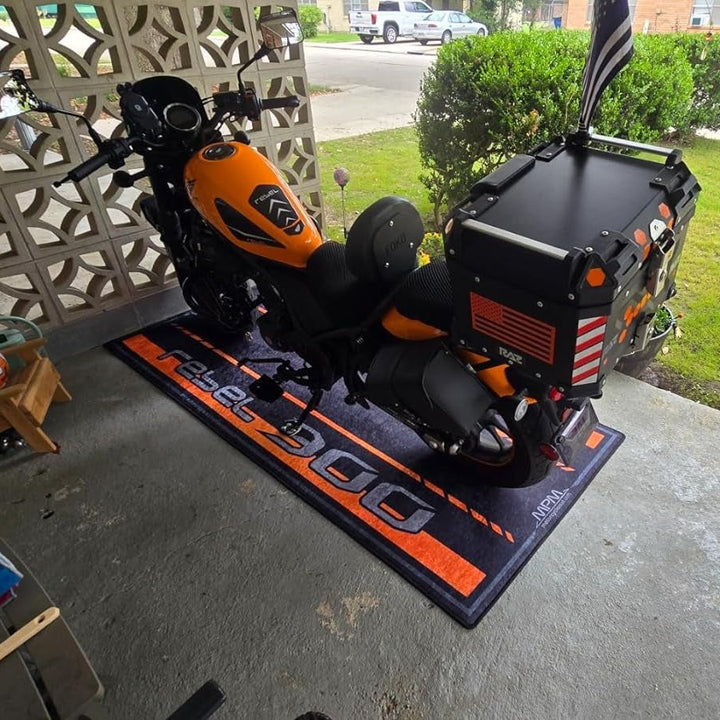 Honda Rebel 300 on custom motorcycle pit mat in outdoor garage setup, non-slip floor cover for cruiser display.