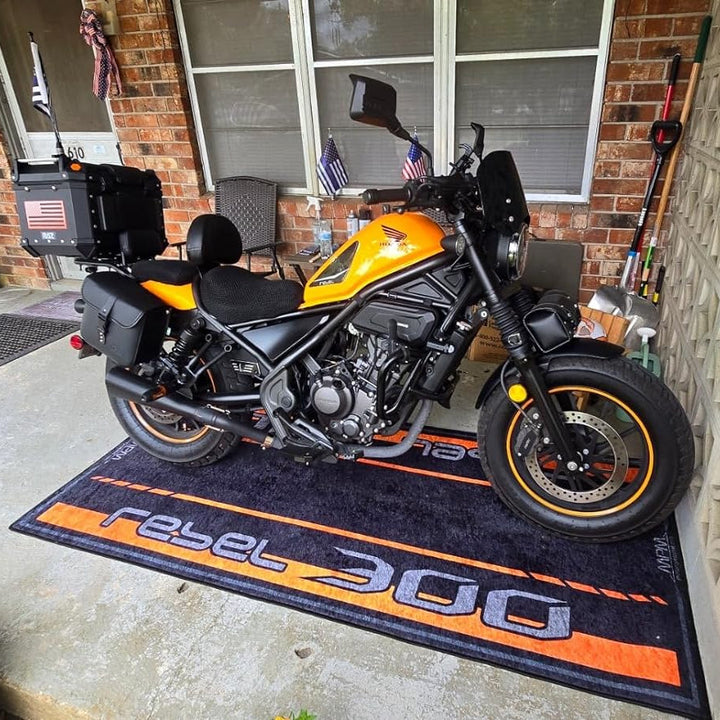 Honda Rebel 300 cruiser motorcycle on personalized garage pit mat, durable non-slip floor rug for home setup.