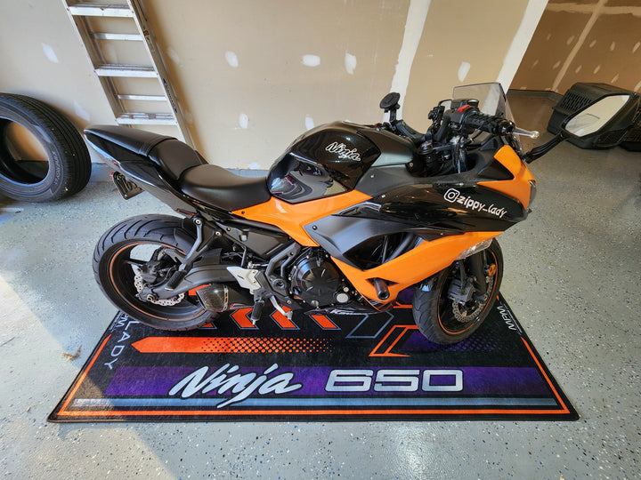 Kawasaki Ninja 650 Black Motorcycle Garage Mat in indoor bike zone showroom setting