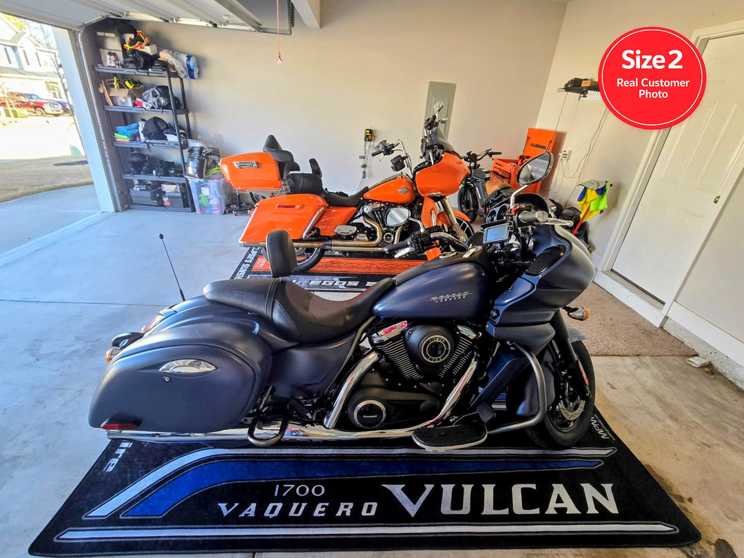 Kawasaki Vulcan Vaquero 1700 on custom motorcycle pit mat in real home garage, non-slip floor cover for cruiser display.