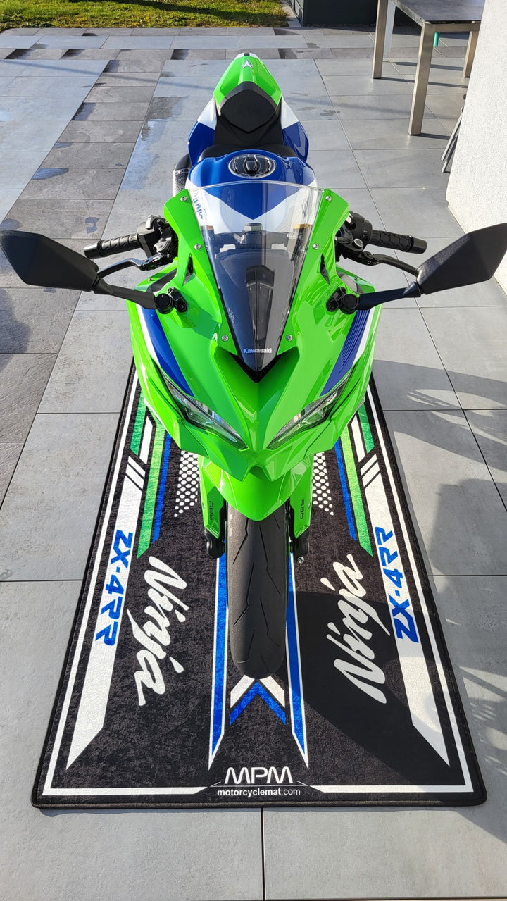 Kawasaki ZX-4RR motorcycle pit mat in real outdoor setup, non-slip garage floor cover for Ninja sportbike display.