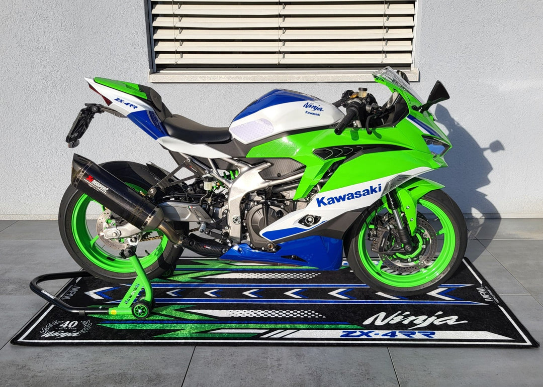Kawasaki ZX-4RR on custom motorcycle pit mat, non-slip garage floor rug for sportbike setup and rider display.