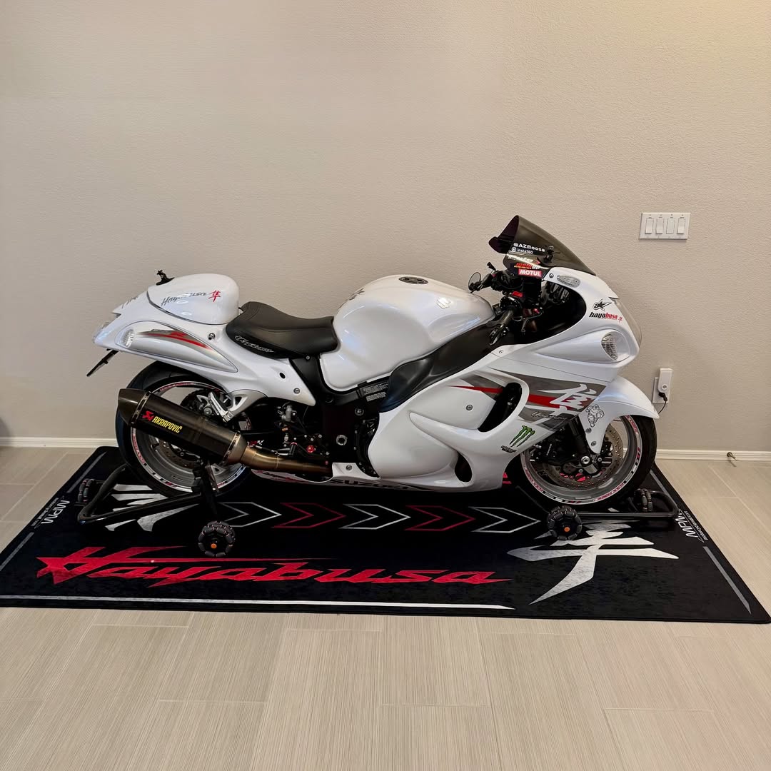 Suzuki Hayabusa on custom motorcycle pit mat in indoor garage, non-slip floor cover for hyperbike display.