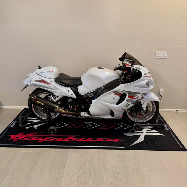 Suzuki Hayabusa on custom motorcycle pit mat in indoor garage, non-slip floor cover for hyperbike display.