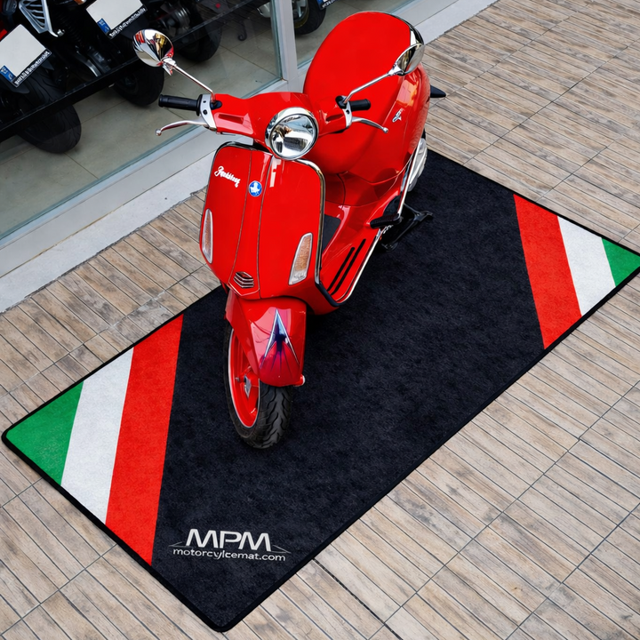 Vespa motorcycle pit mat for scooter display, durable non-slip garage floor cover in real indoor setup.