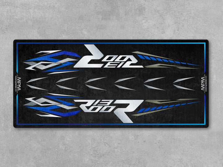 High-performance parking mat made with Thermoplastic Rubber. Designed for motorcycle display, racetrack vibes, and dual sport setup.